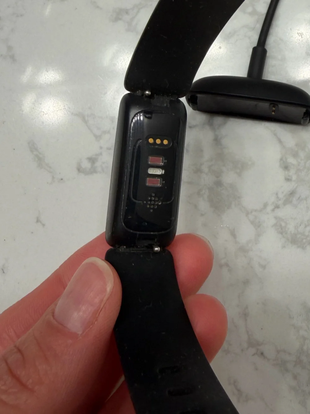 Black Fitbit Inspire Fitness Tracker Smartband with charging cord